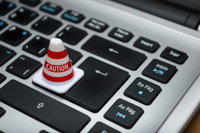 A laptop keyboard features a red and white cone, highlighting data privacy.