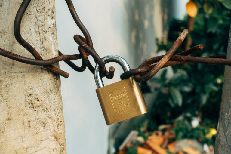 A padlock secures a barbed wire fence, highlighting the importance of data privacy in digital marketing by 2023.