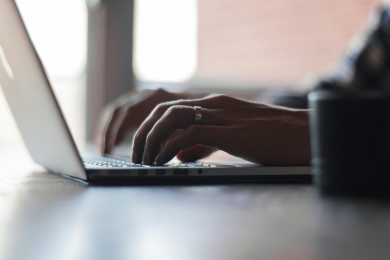 Person typing at a laptop